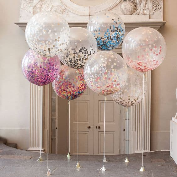 Transparent balloons with colorful confetti.