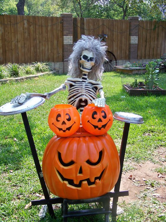 Skeleton musician with pumpkin instruments.