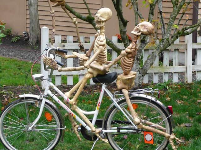 Skeletons having fun on a bike.