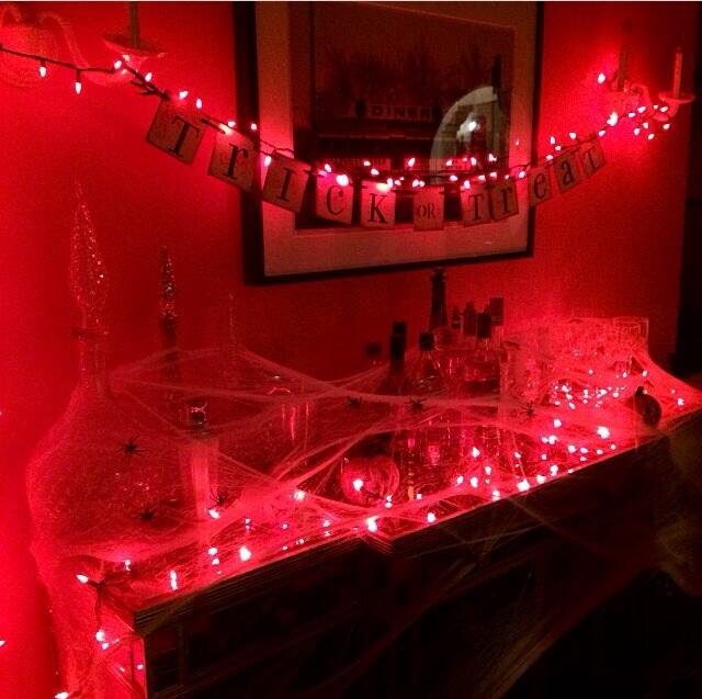 The orange lights sets the mood for classy indoor Halloween decor